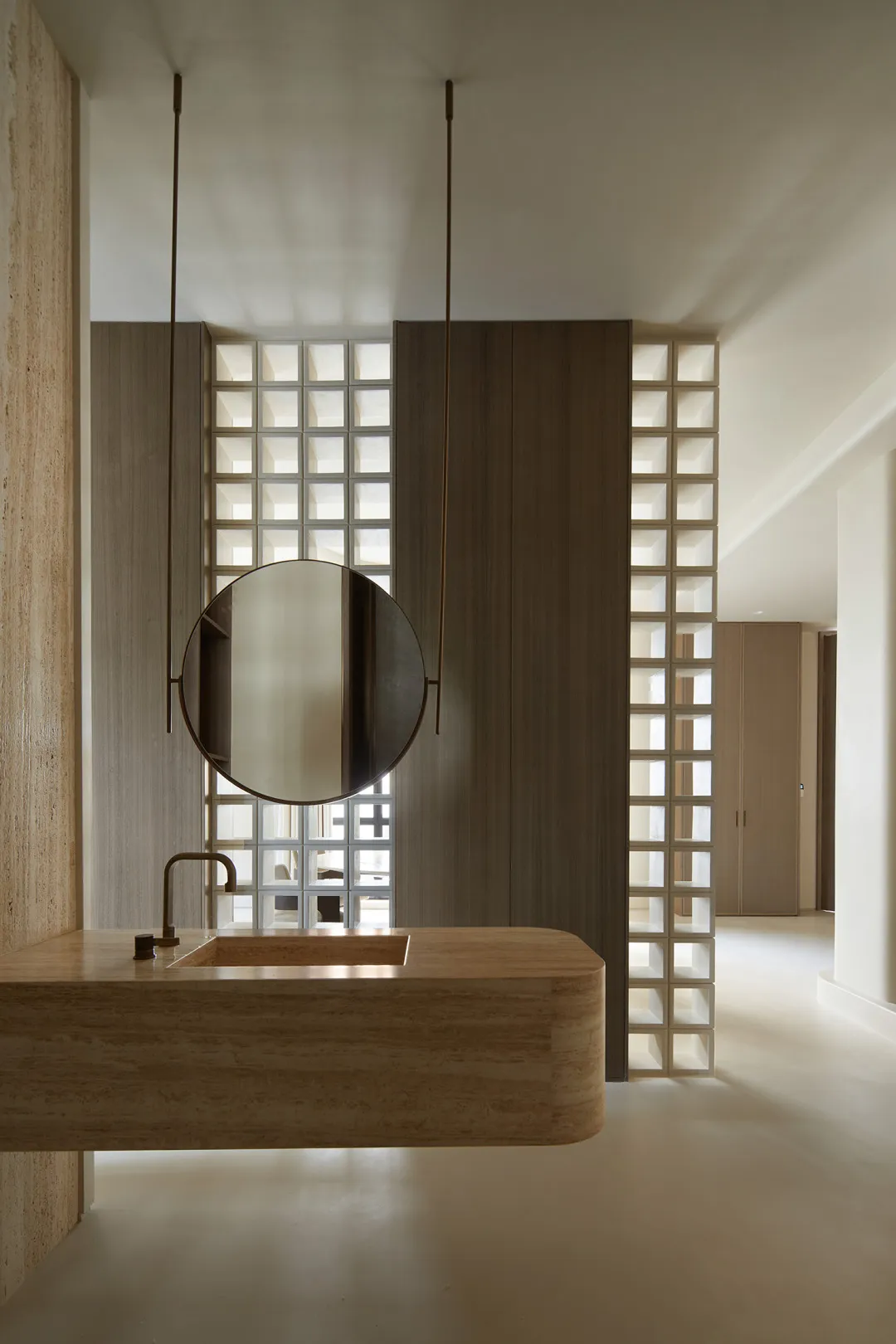 A modern minimalist bathroom featuring a marble sink and wooden accents.