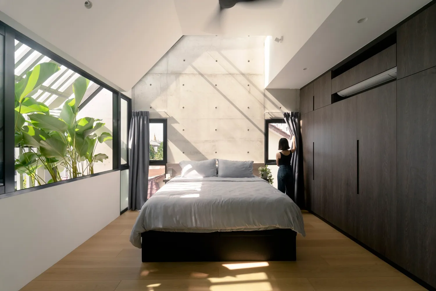 Modern minimalist bedroom featuring minimalist design with concrete and wooden elements