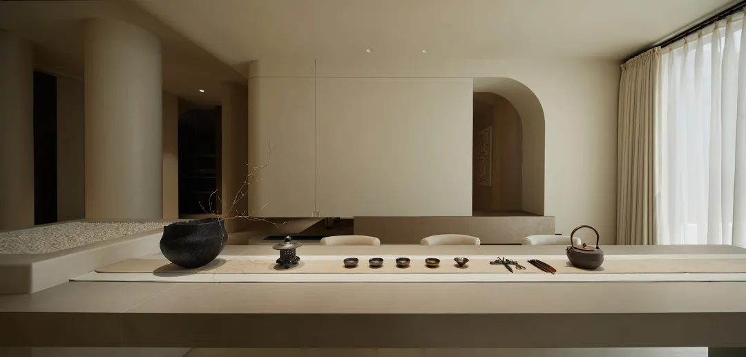 A minimalist interior design space featuring neutral-toned materials and modern furnishings.
