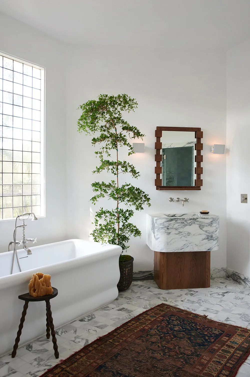 Modern bathroom interior with marble sink, wooden vanity, and glass window.