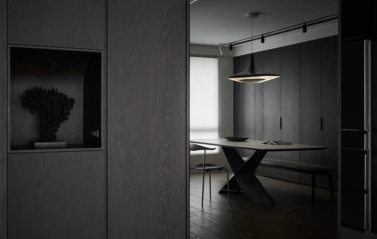 Modern dining room with dark wood furniture and minimalist design.