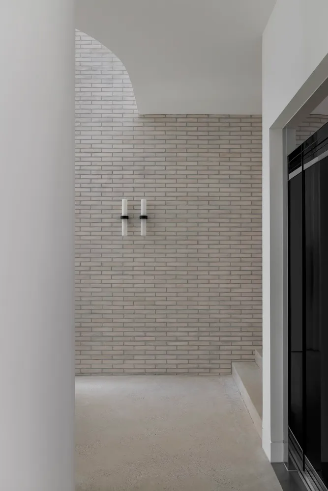 Minimalist interior design featuring brick and concrete materials