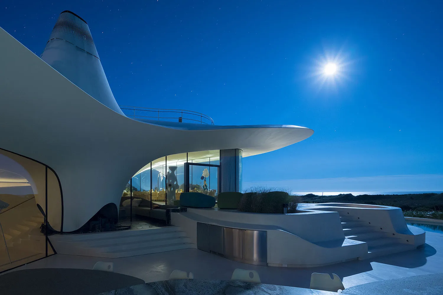 Modern residential exterior featuring extensive use of glass.