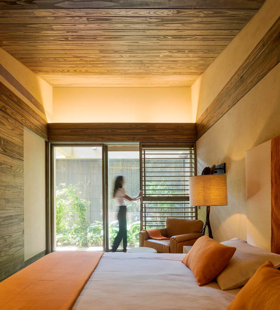 A modern bedroom suite featuring wood elements and natural light.