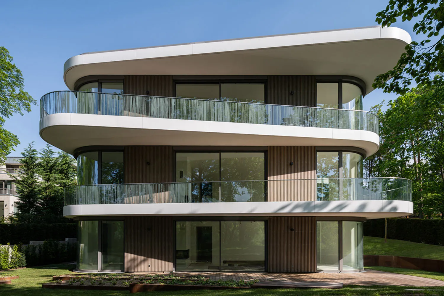 A modern house with wooden cladding and large glass windows.
