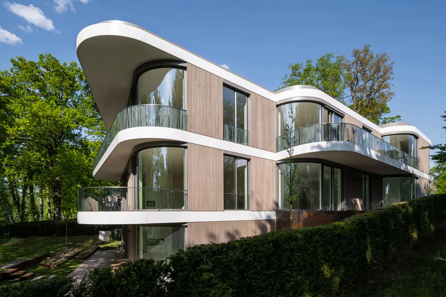 A modern residential building featuring wood and glass materials.