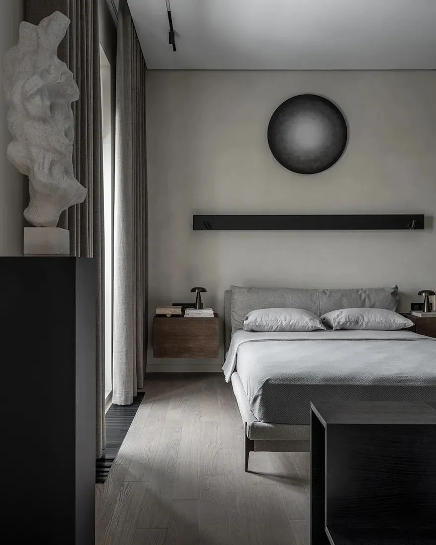 Modern bedroom with a cozy layout, showcasing a textured wooden floor, soft fabric bedding, and sleek metal accents.
