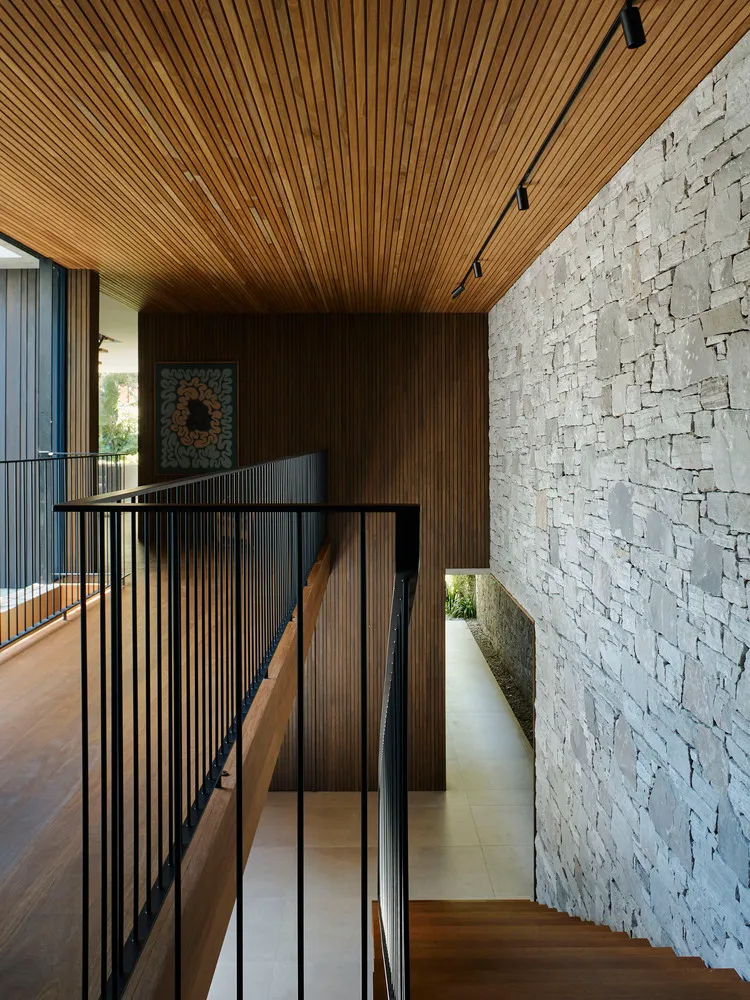 A modern interior with a wooden staircase and terraced walls.