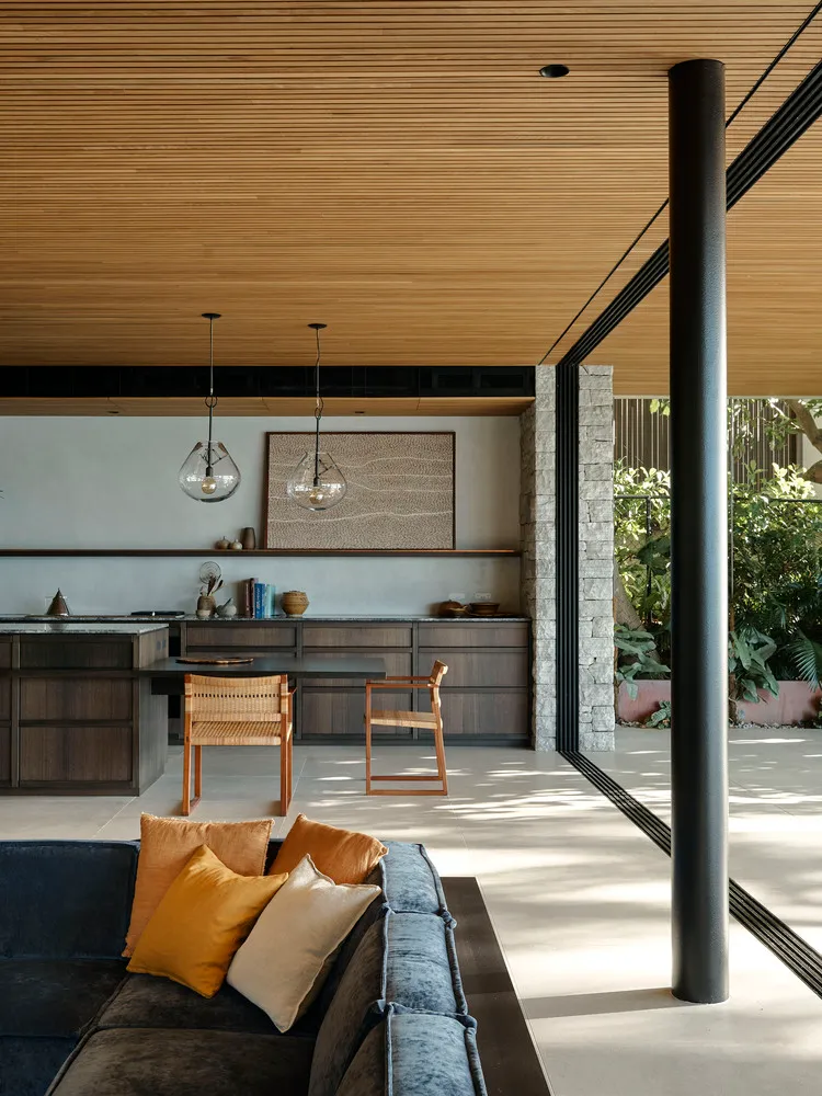 Modern living room with wooden ceiling and furniture.