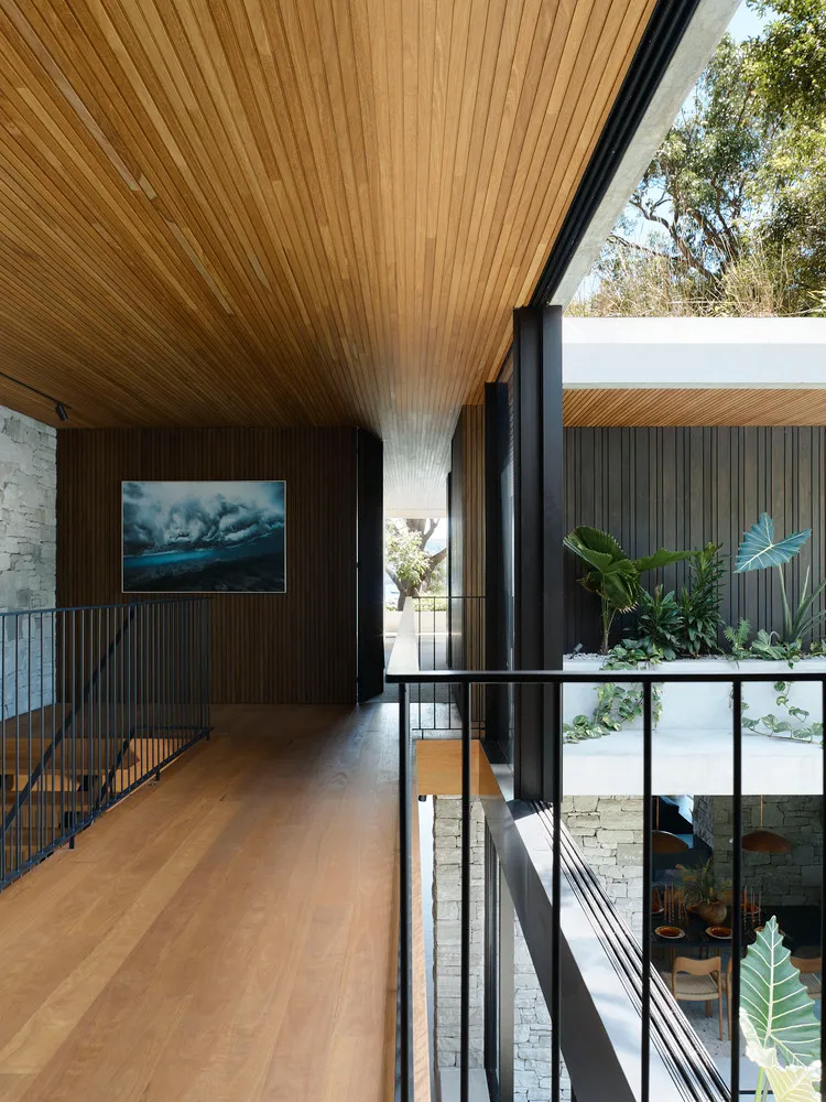 A modern interior design with wooden flooring, concrete walls, and glass elements.