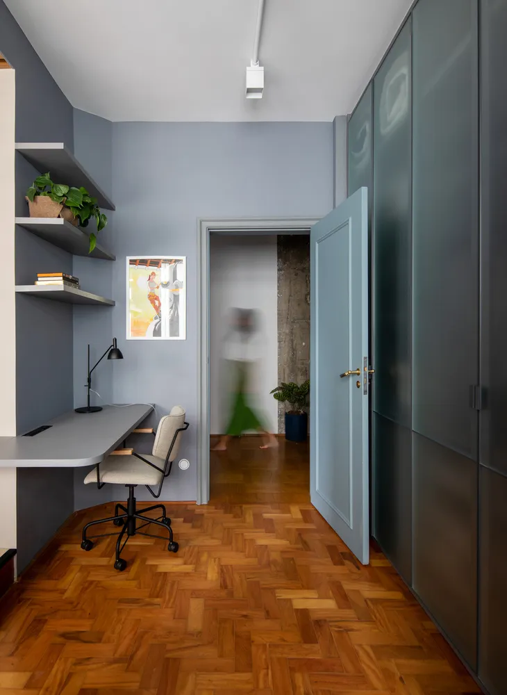 Modern minimalist home office with a wood floor and minimalist furniture