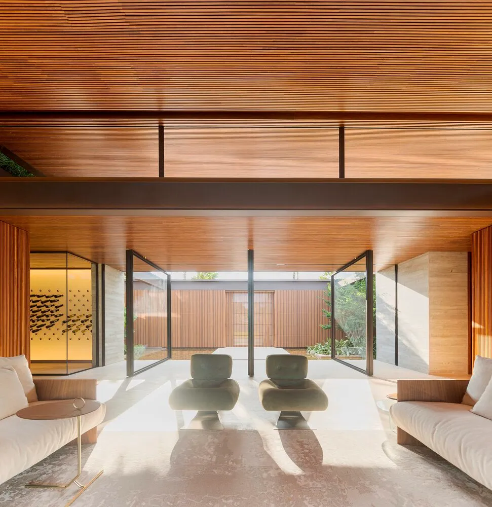 A modern living room featuring wooden walls and furniture.