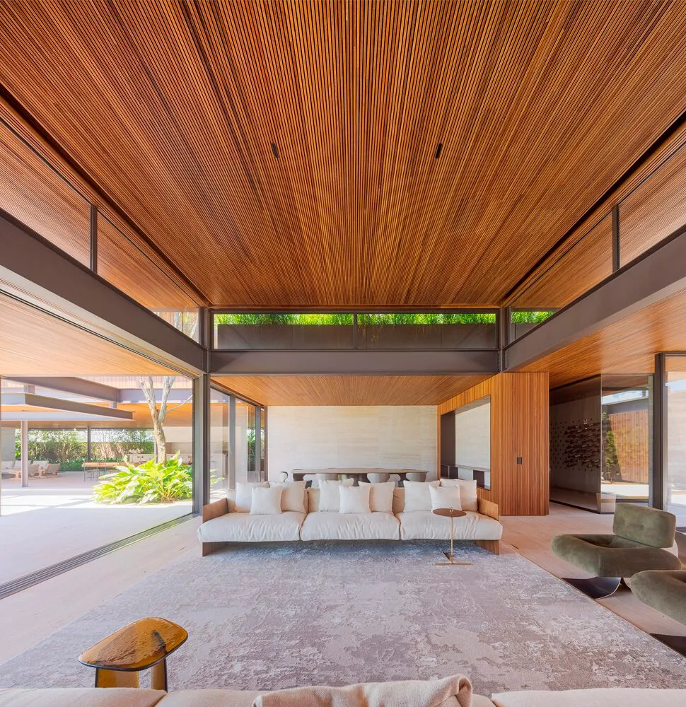 A modern residential living room featuring concrete floor tiles and minimalist furniture.