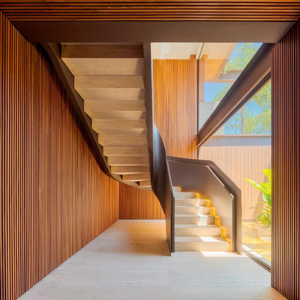 A modern wooden staircase indoors with natural light.