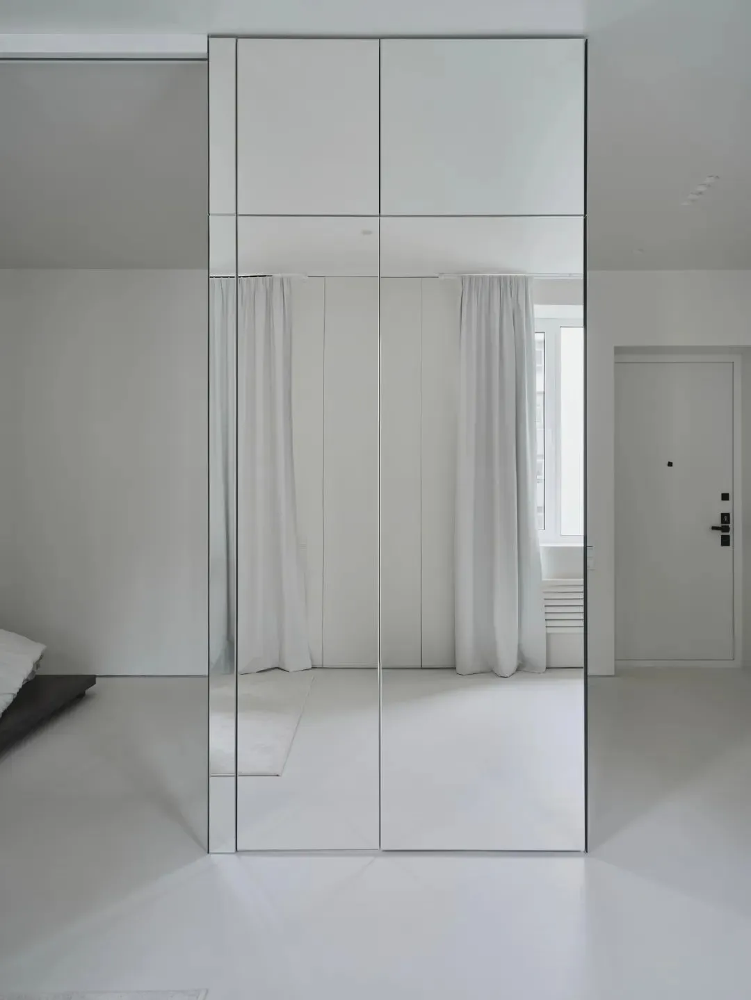Modern bathroom with white walls, floor, and glass wall