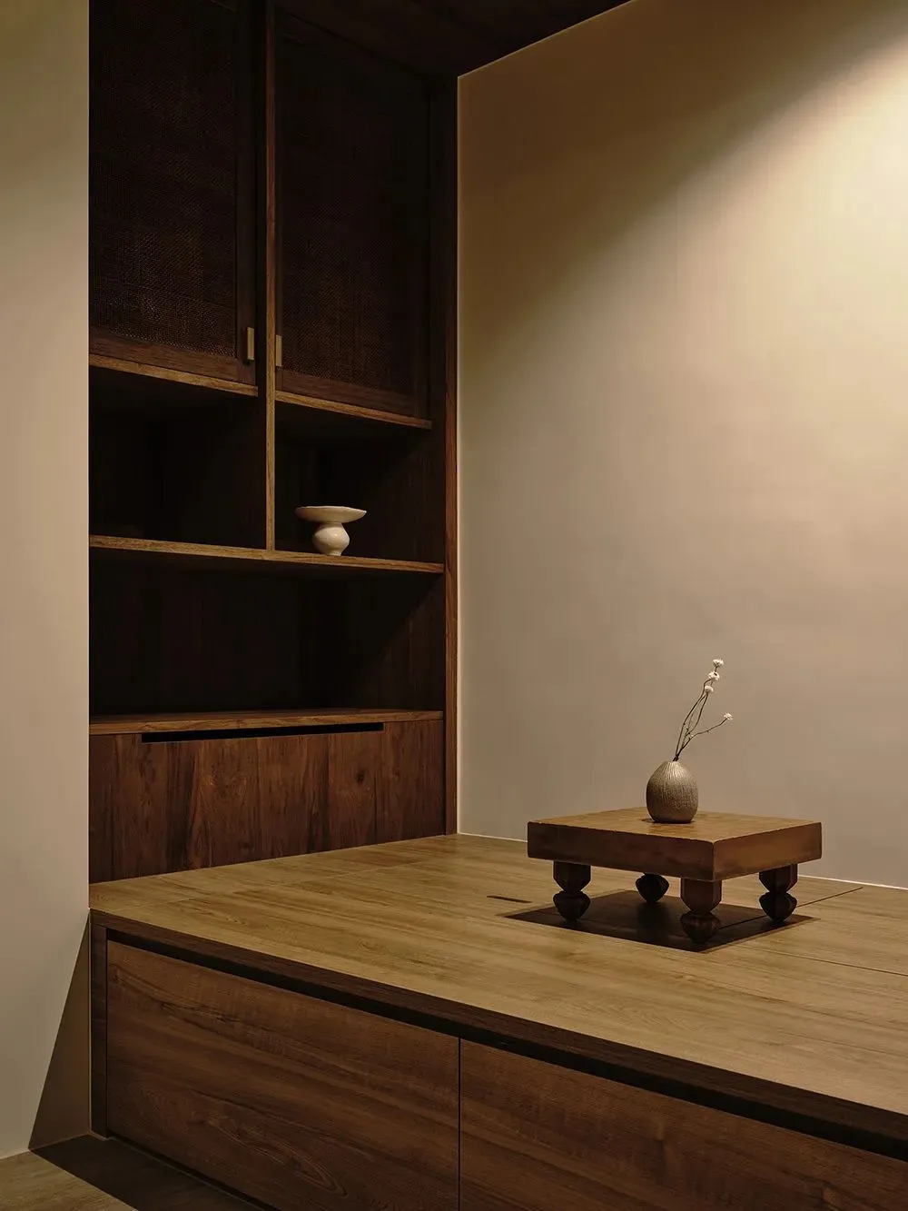 A minimalist office space featuring wooden furniture and decor.