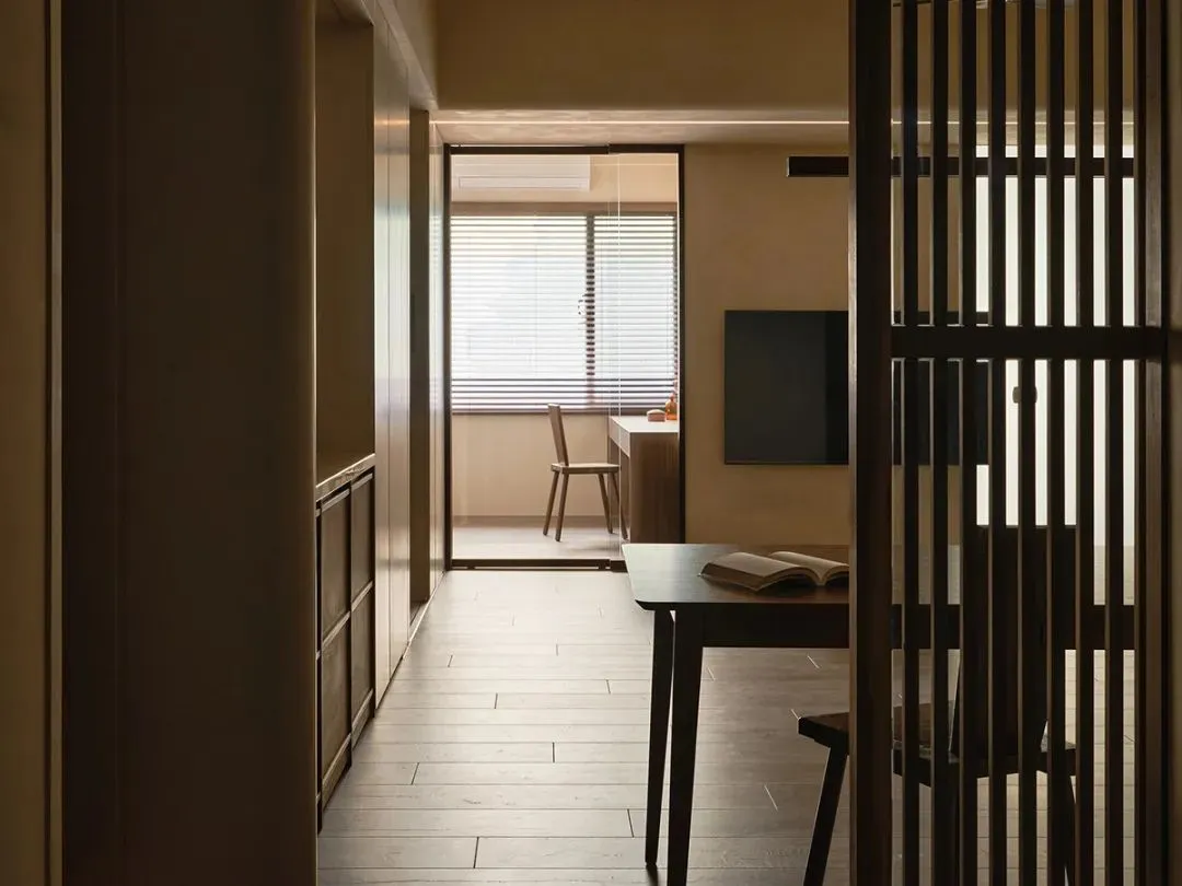 Home office featuring modern, wooden furnishings with a sleek desk and minimalist decor.