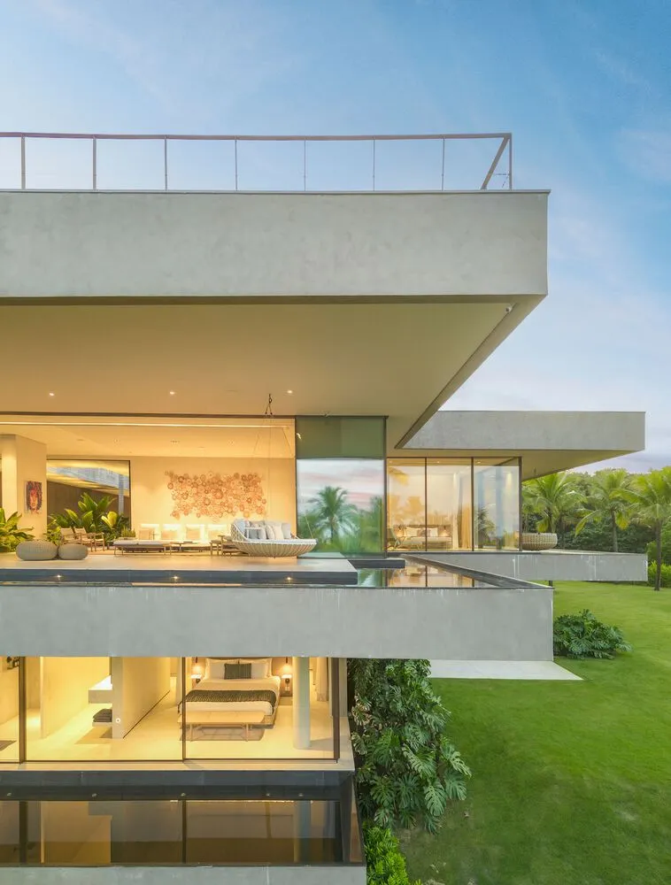 A modern residential extension with a concrete facade and large glass windows.