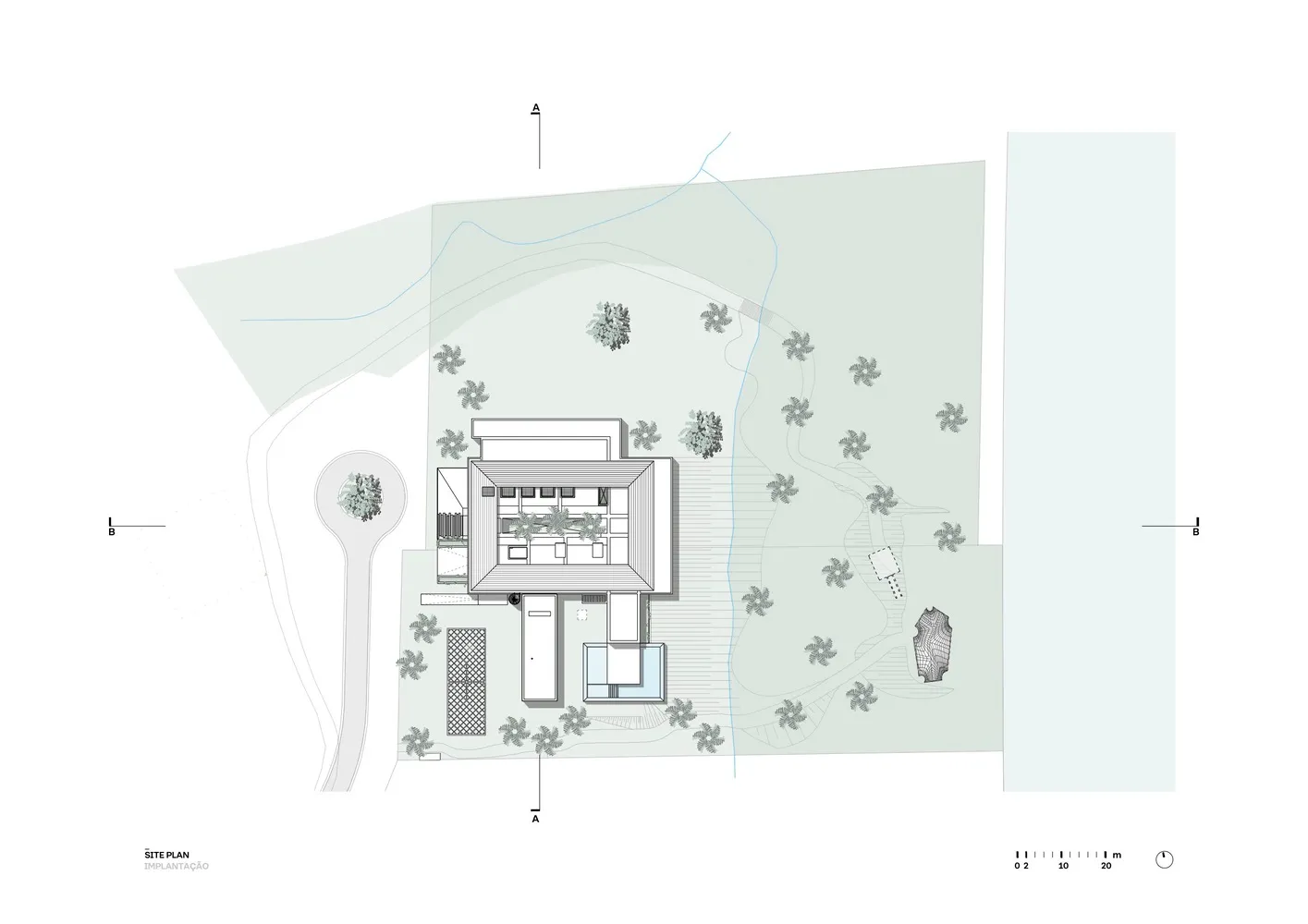 A modern site plan with a building, trees, and pathways