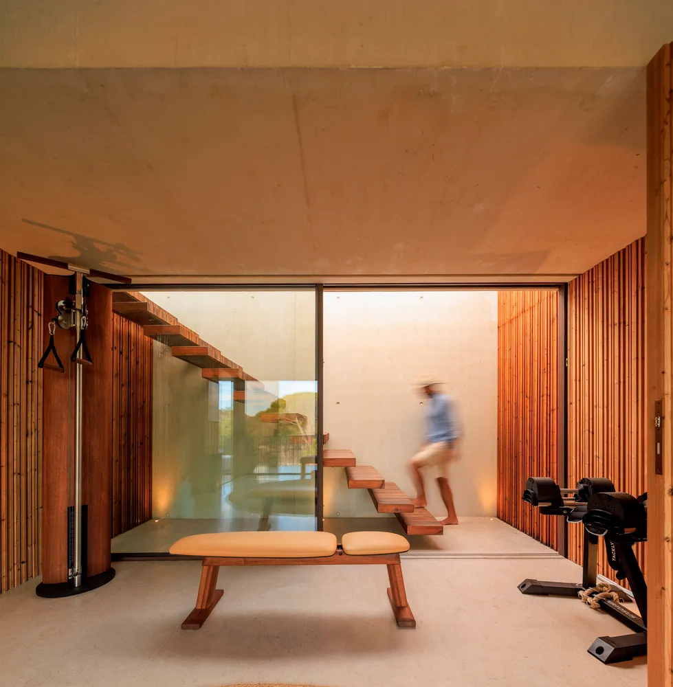 Modern industrial-style fitness studio with wooden elements and exercise equipment.