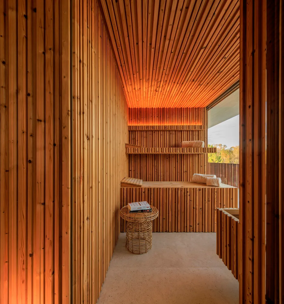A spa room with wooden paneling, shelves, and a woven basket.