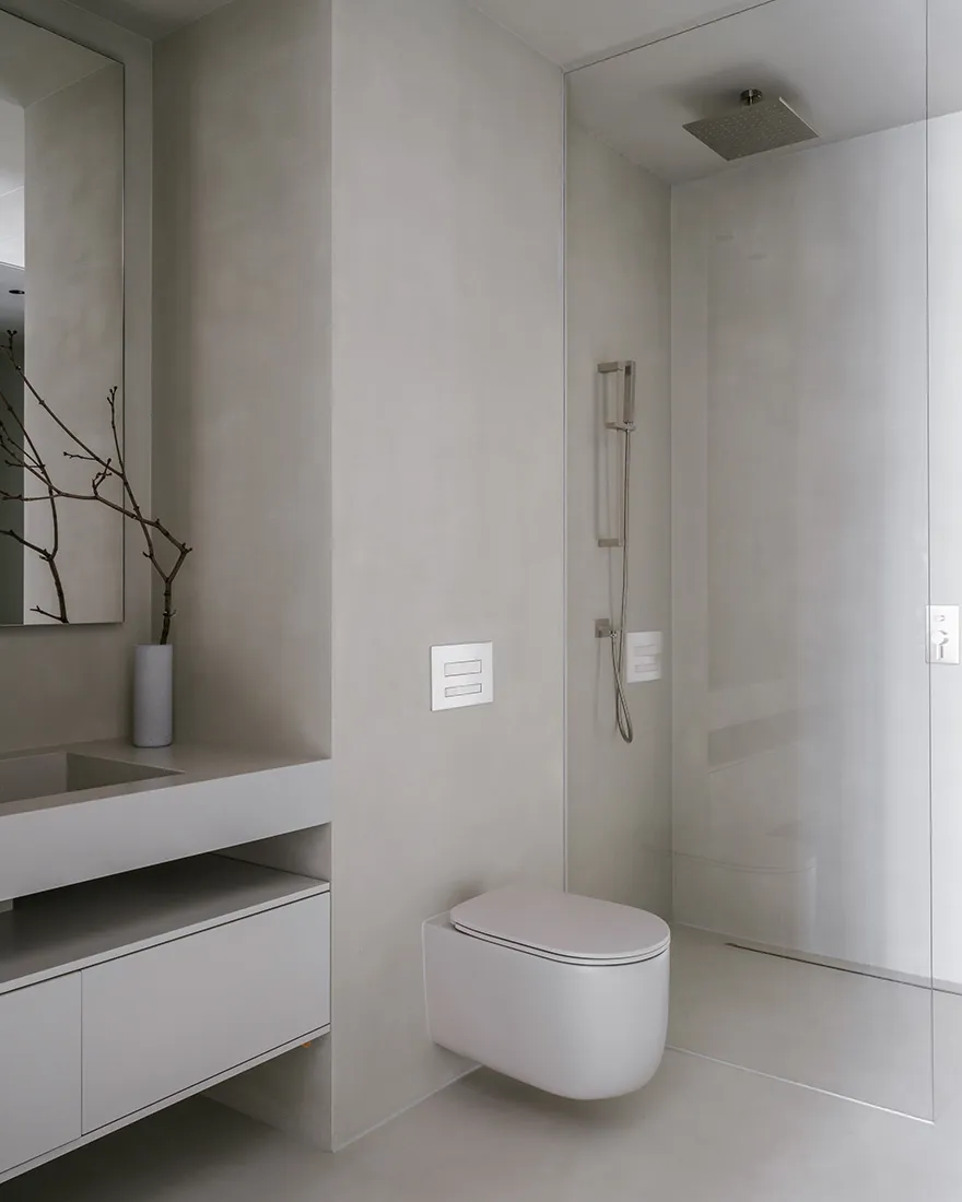 Minimalist modern bathroom with concrete walls and floor.