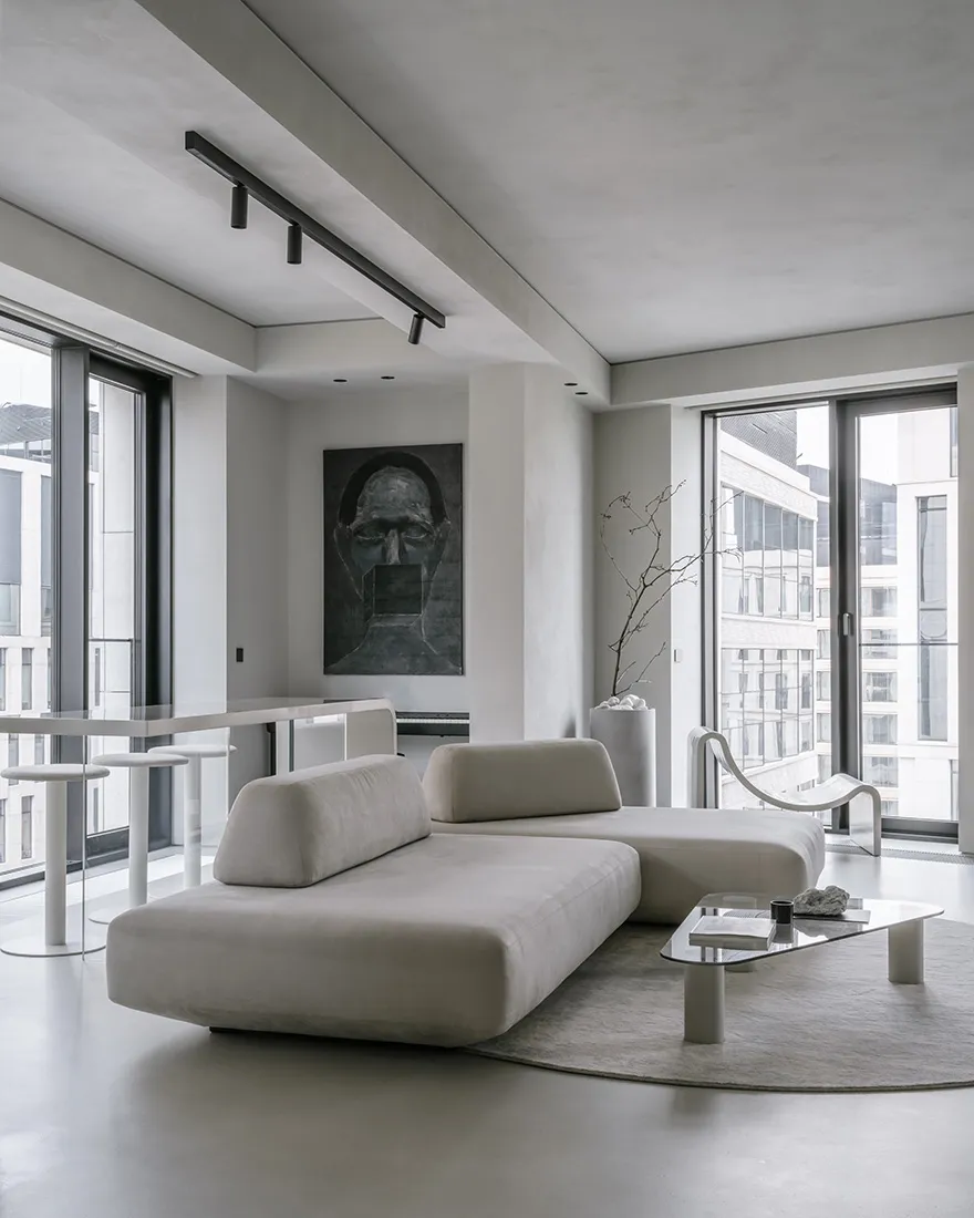 Modern living room featuring a textured concrete floor and contemporary furniture.