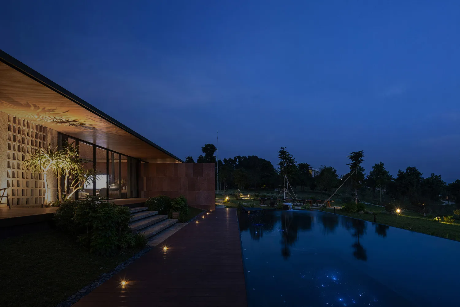 A modern house with exterior lighting at dusk.