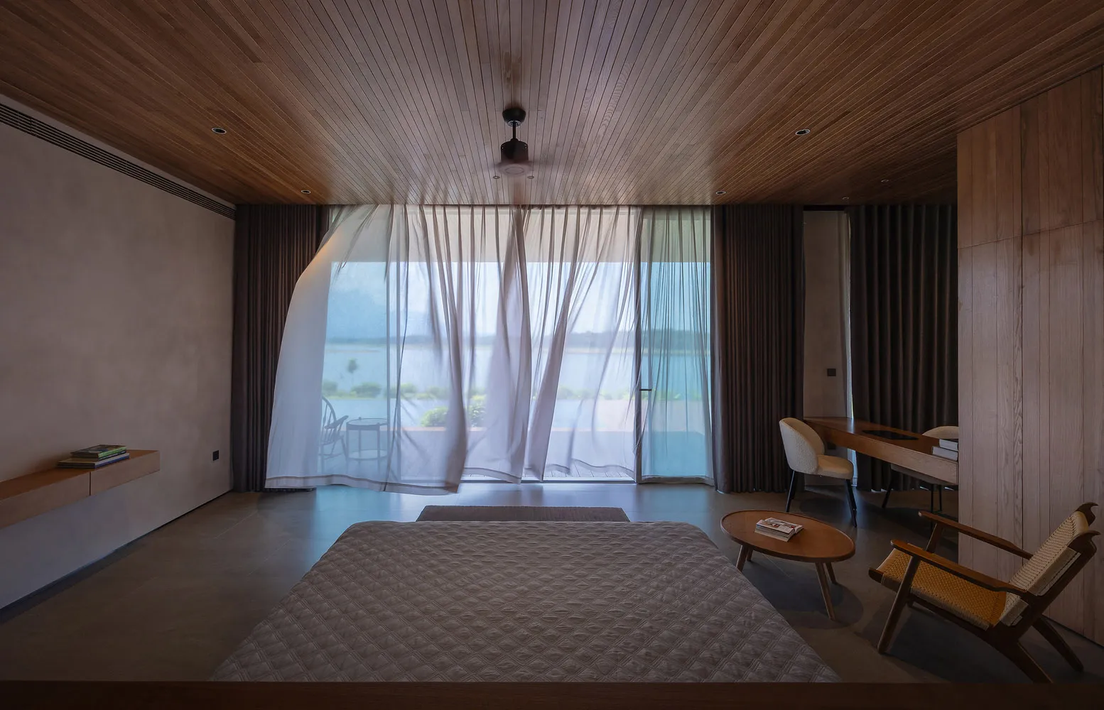 Modern minimalist bedroom featuring wooden furniture and ceiling with a serene view.