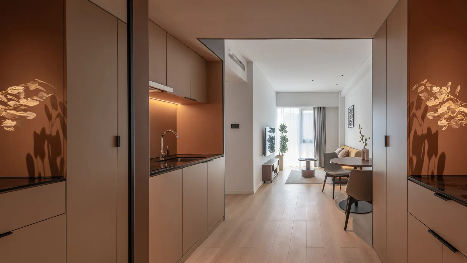 Modern minimalist residential kitchen with terrazzo countertops and warm lighting, showcasing contemporary design features.