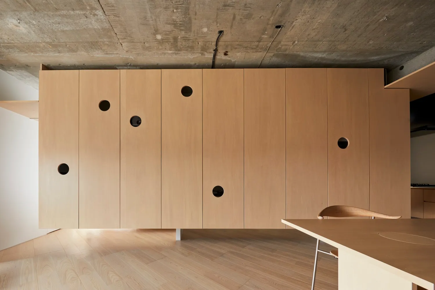 Modern interior design with wooden cabinets and concrete ceiling