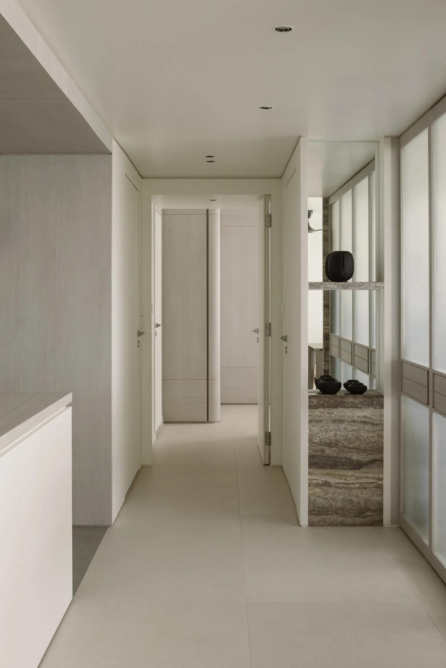 Modern minimalist hallway with neutral tones and wood details.