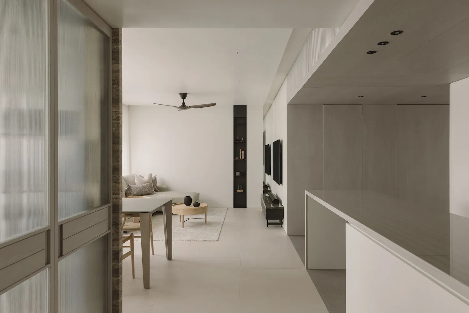 Modern minimalist living room with neutral color palette and sleek furniture.