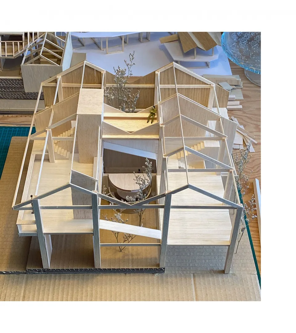 A detailed architectural model of a house constructed from wood.