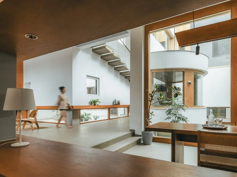 A contemporary space featuring concrete walls and floor, with a minimalist aesthetic and natural light.