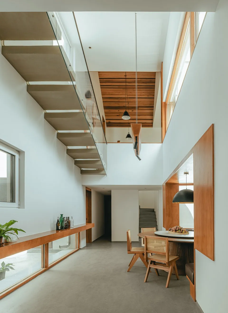 Modern interior space featuring wooden, concrete, and glass elements.