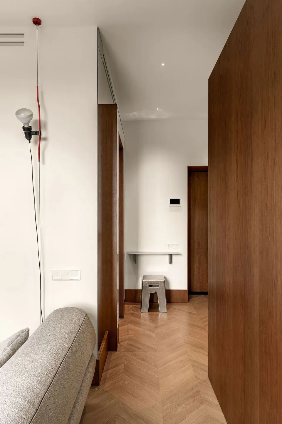 A modern living room with wooden flooring and minimalist design elements.