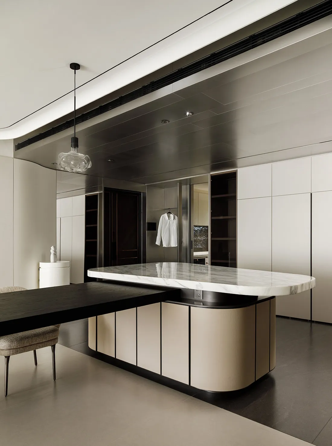 A modern minimalist kitchen featuring marble countertops.