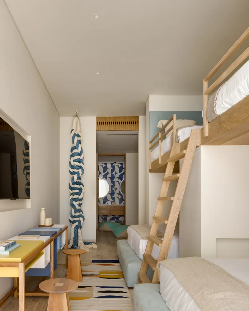 A modern Scandinavian apartment with light wood furniture, colorful textiles, and natural fabrics placed in the interior desi