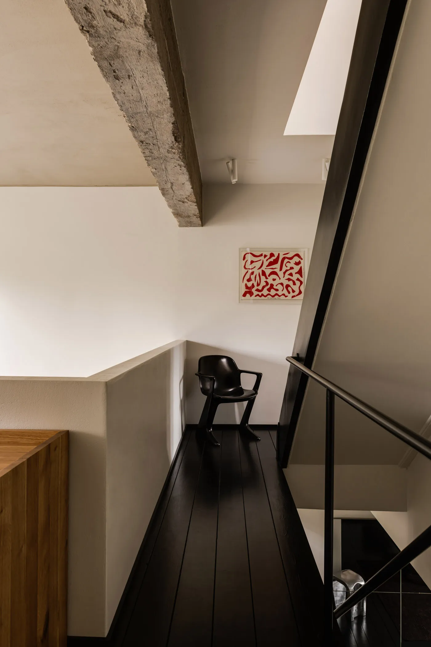 A modern loft interior featuring exposed concrete and wooden floors.