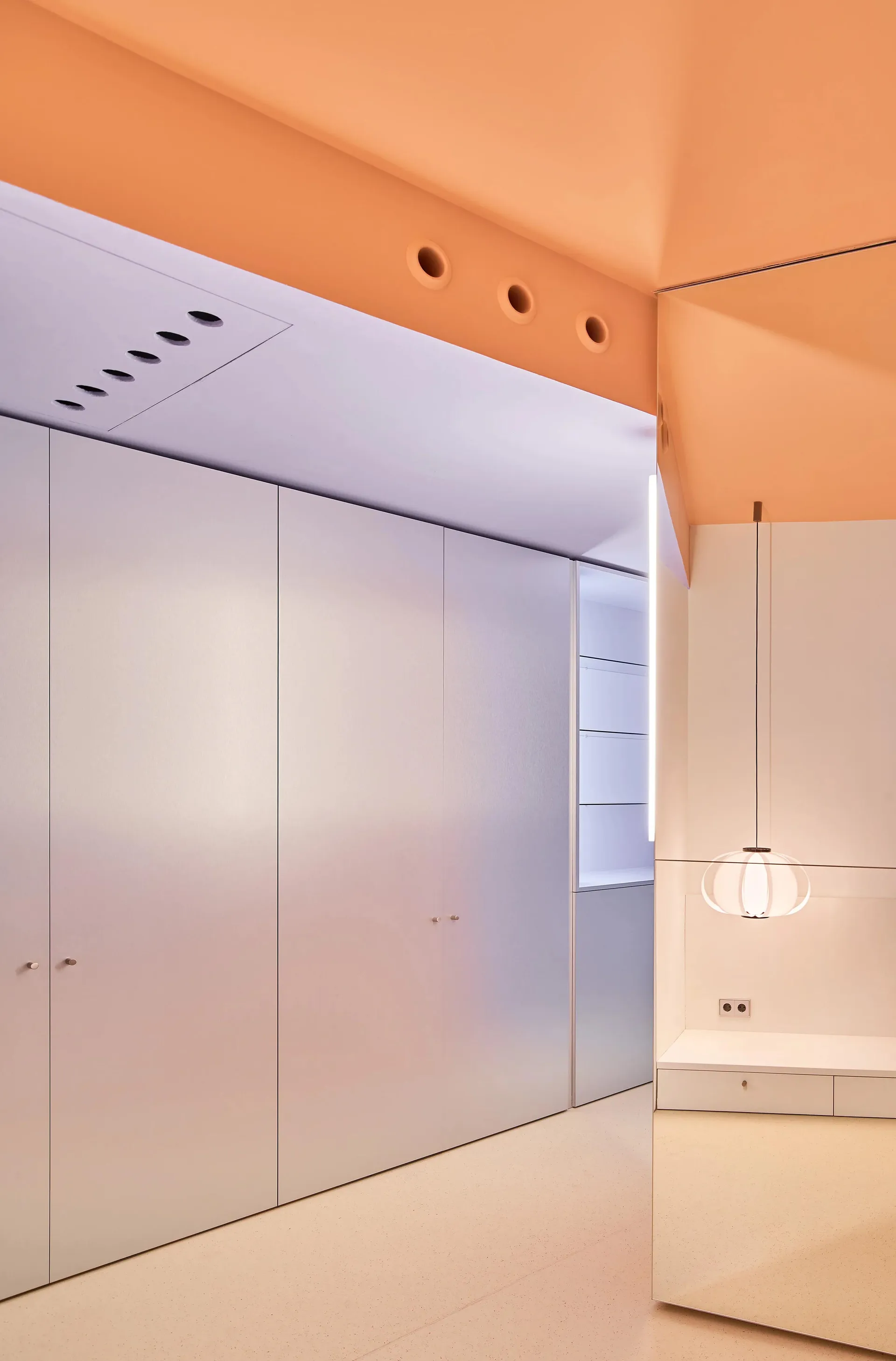 A minimalist bedroom featuring modern concrete walls and a white ceiling.