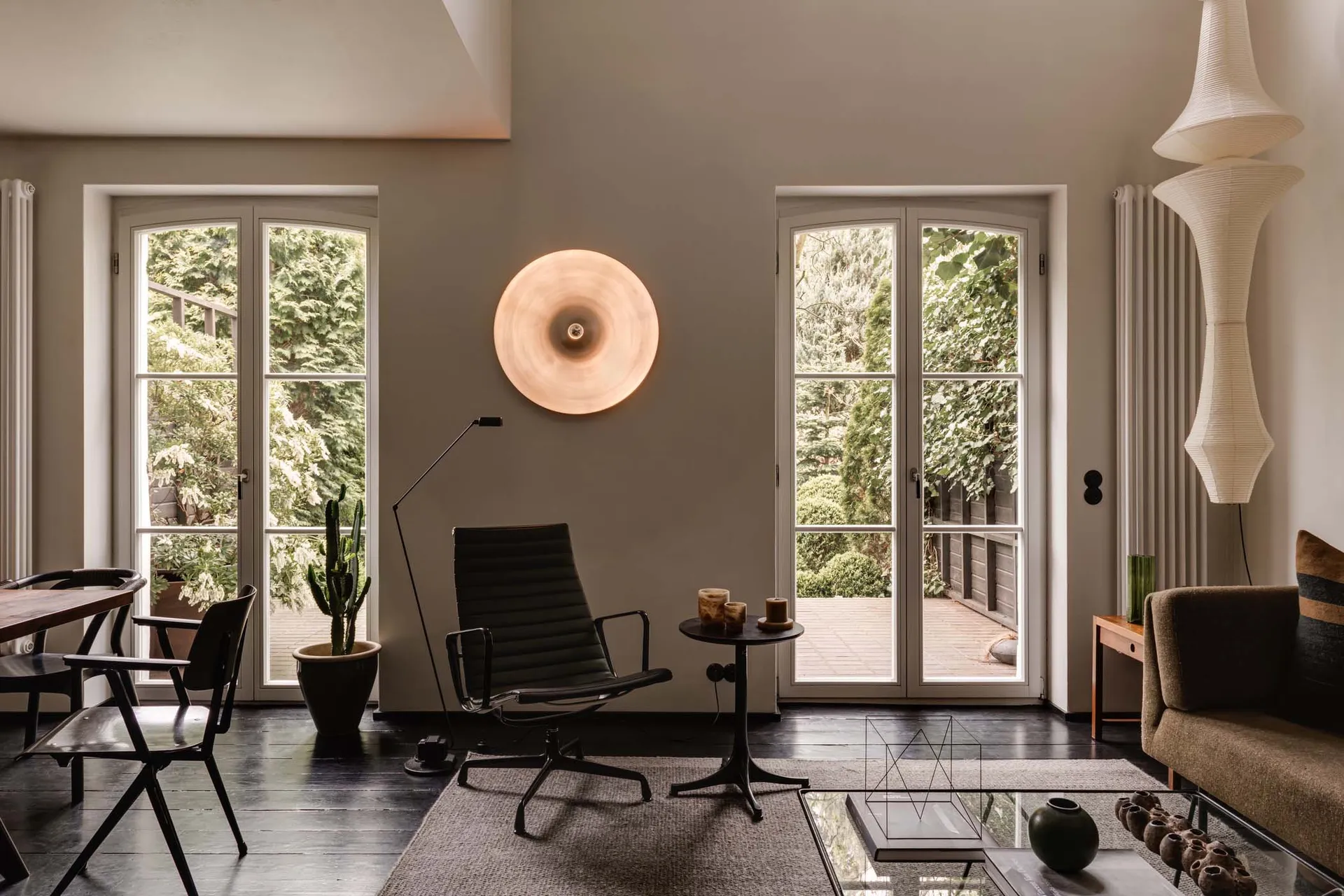 A modern living room featuring neutral-colored walls, furniture, and decor.