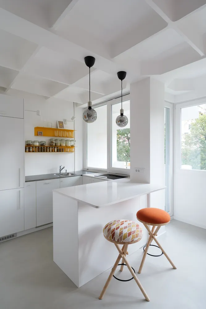 White, minimalist kitchen with a modern design.