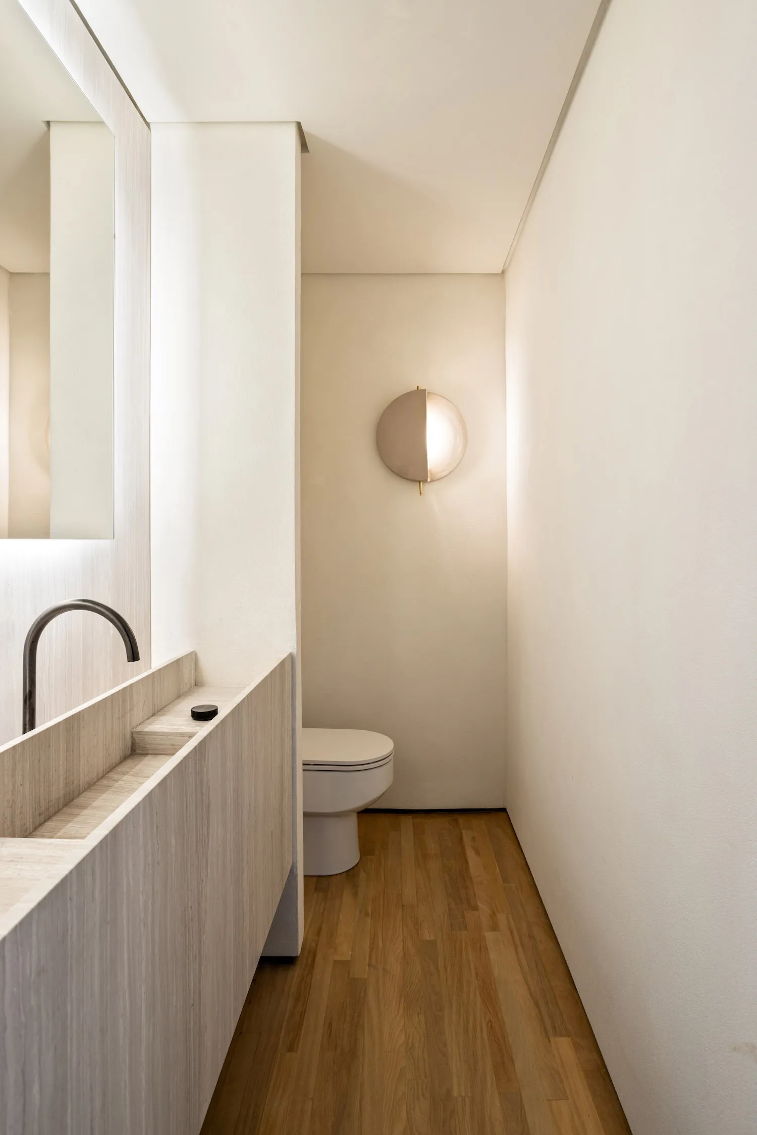 Modern minimalist bathroom with concrete sink and floor, featuring a sleek, clean design.