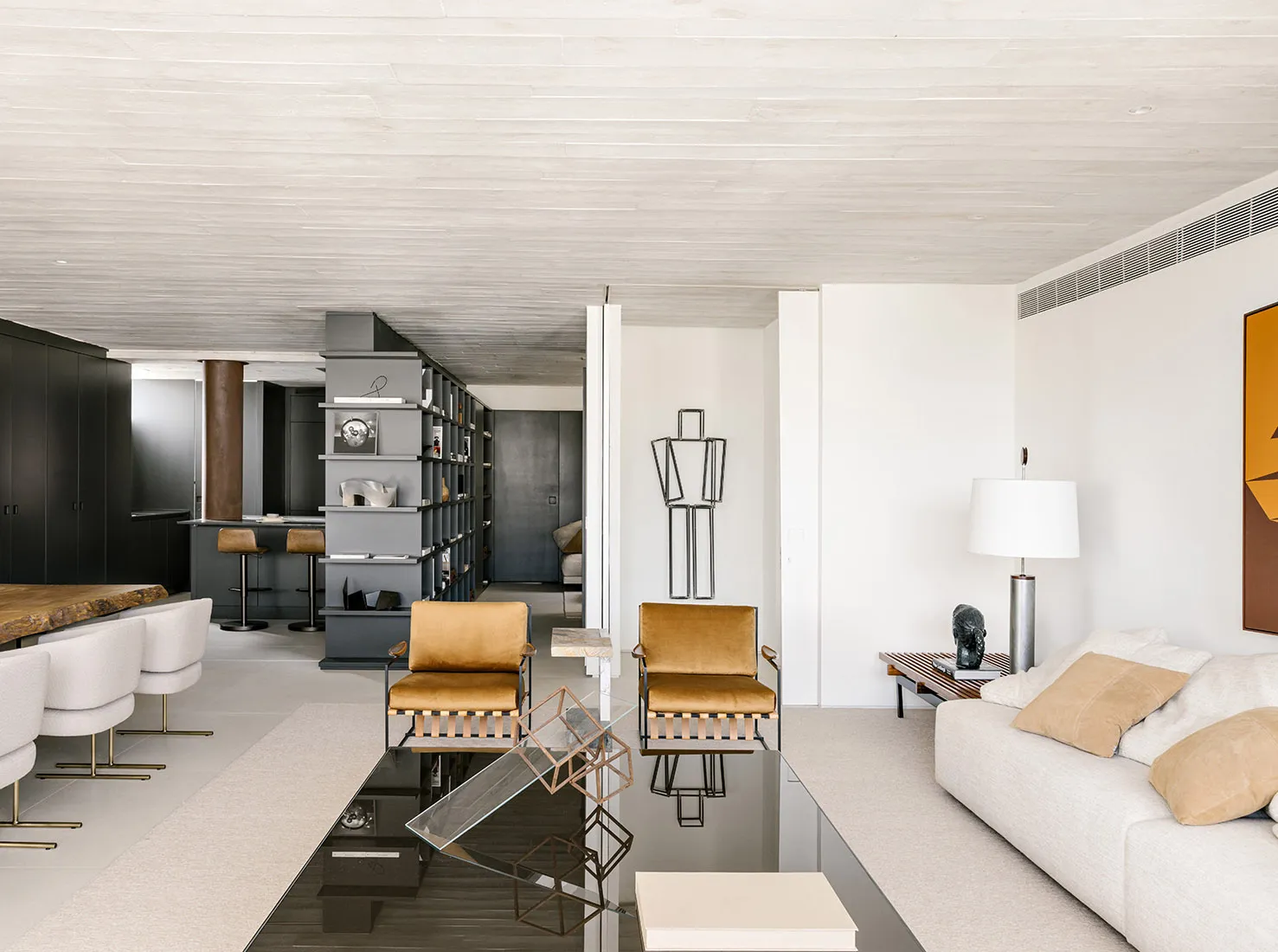Modern minimalist living room with white walls, wooden floor, and minimalist furniture.