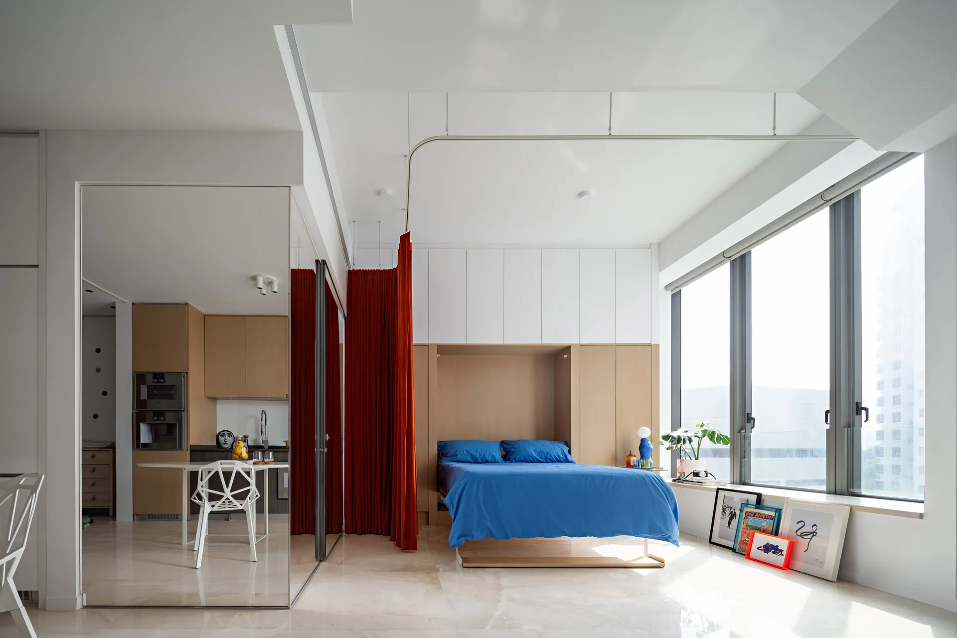 Modern minimalist living room featuring clean lines, wood and glass furniture, and a large window.