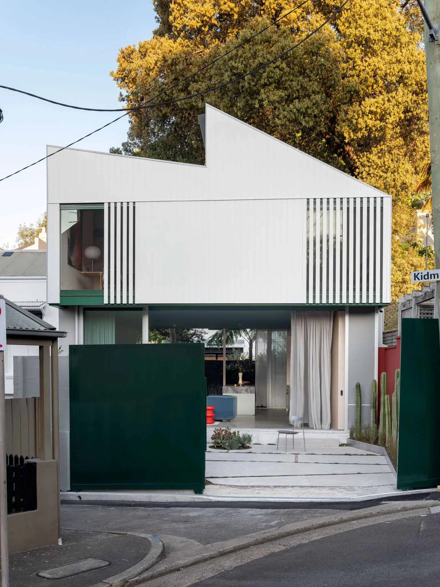 A modern house with an exterior made of metallic panels.