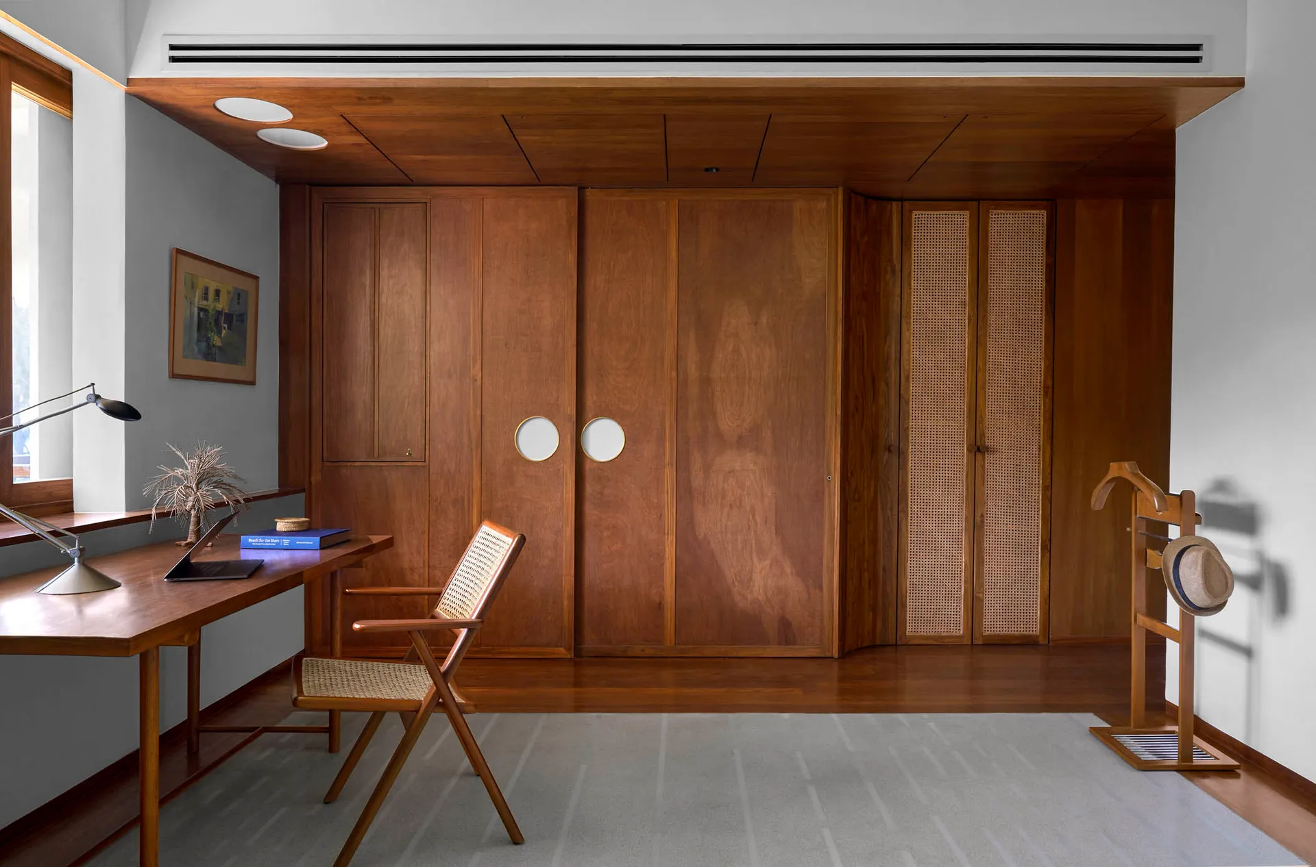 A modern industrial home office with wooden walls and furniture