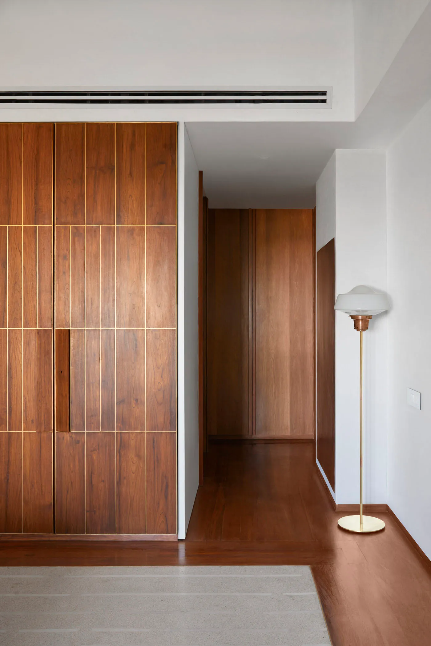 Modern apartment featuring wooden wardrobes and a sleek, minimalist design.