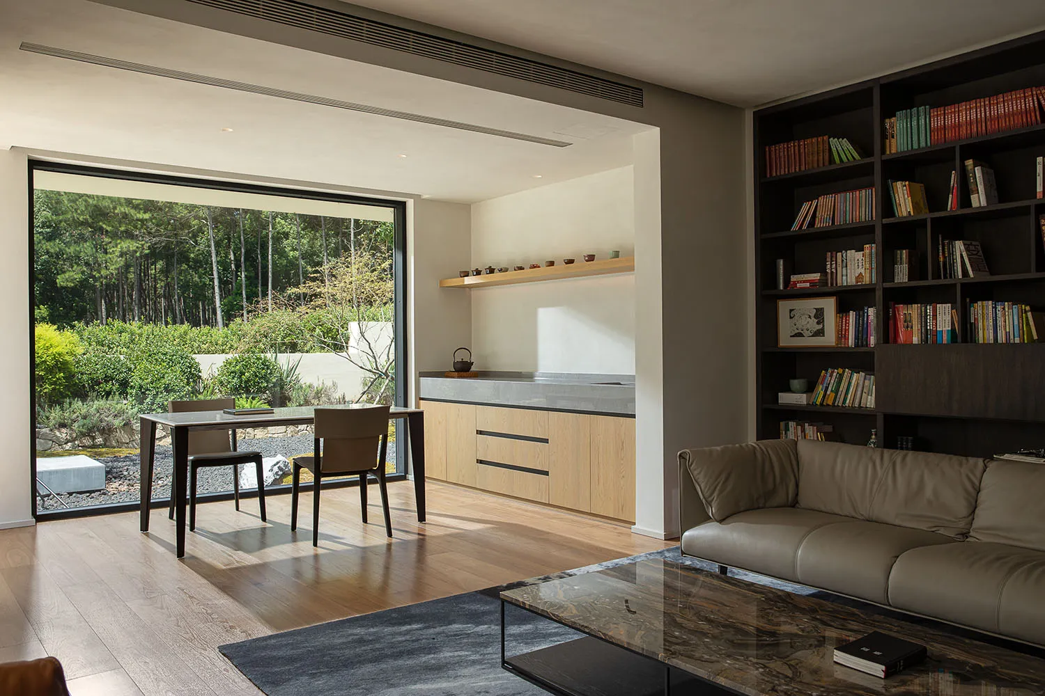 Modern living room with wooden floors and integrated kitchen area
